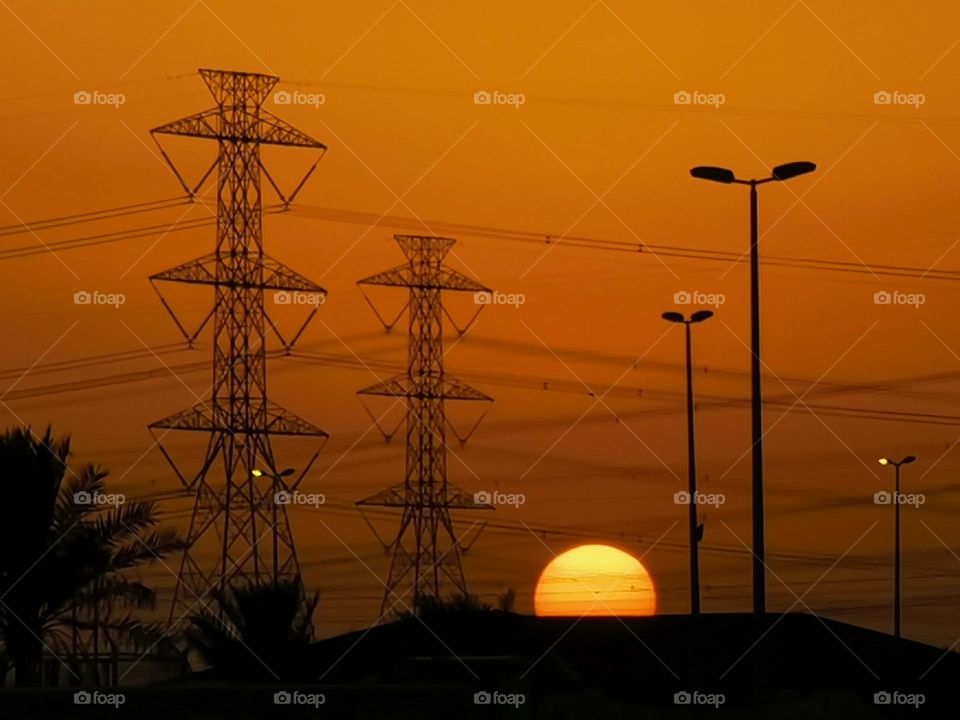 “At sunrise, the blue sky paints herself with gold colors and joyfully dances to the music of a morning breeze.