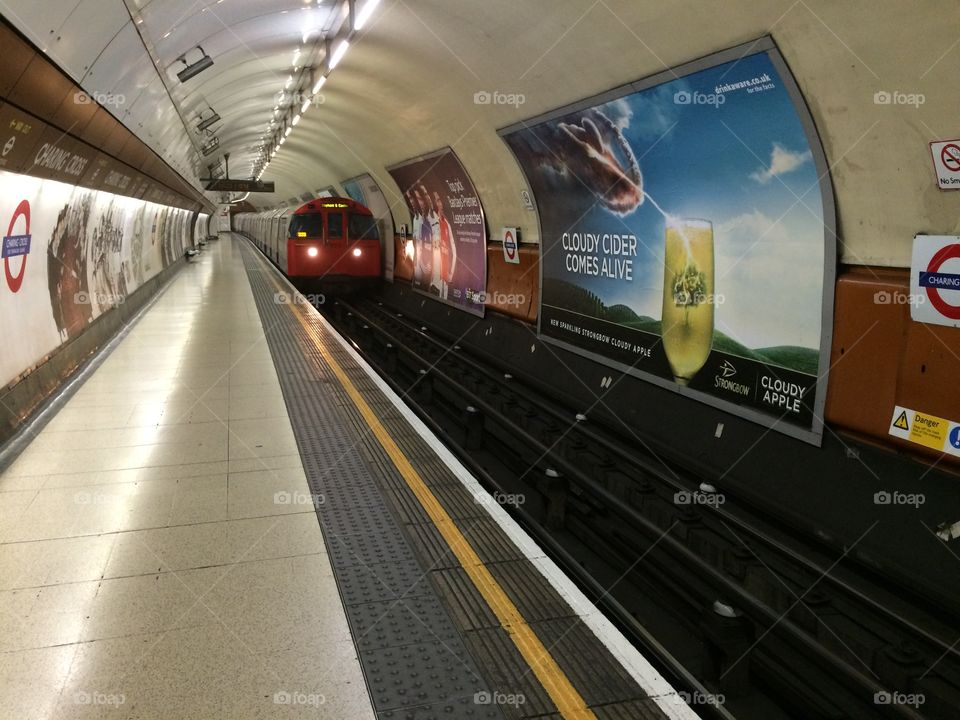 Train approaching . Empty tube platform with train approaching 