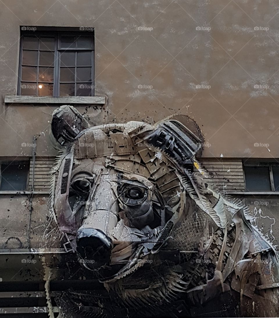Ecological art installation of a bear made from metal waste and garbage