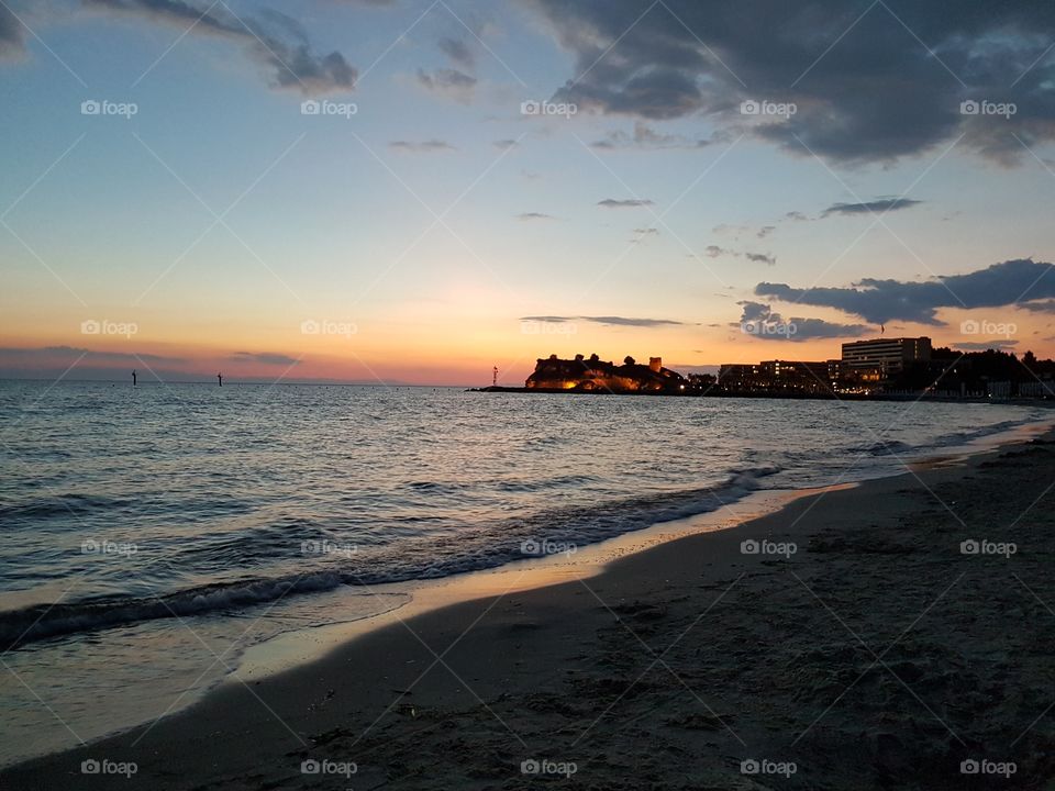 beach sunset, in the background is summer resort Sani beach, Greece, Europe