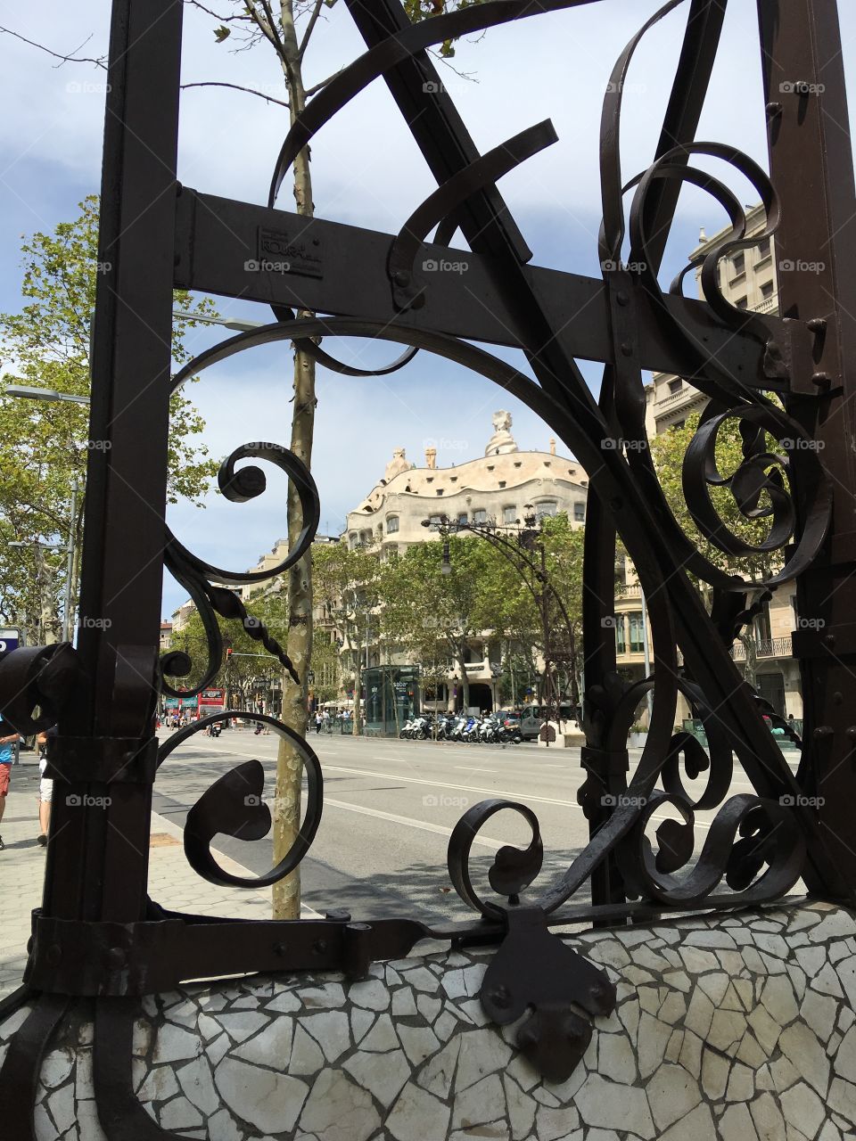 View of casa mila through iron lamppost in gothic district 