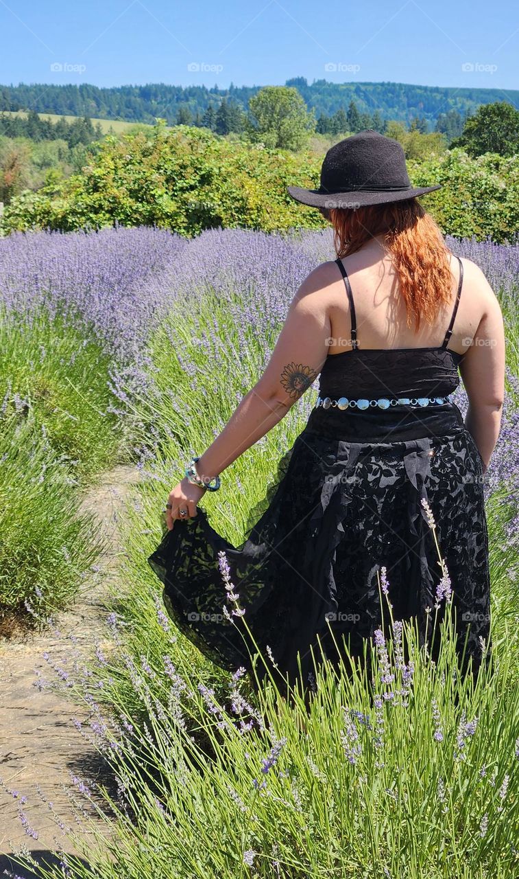 spirited fashionable young woman enjoying a pause moment on a hot Oregon Summer day in lavender flower field