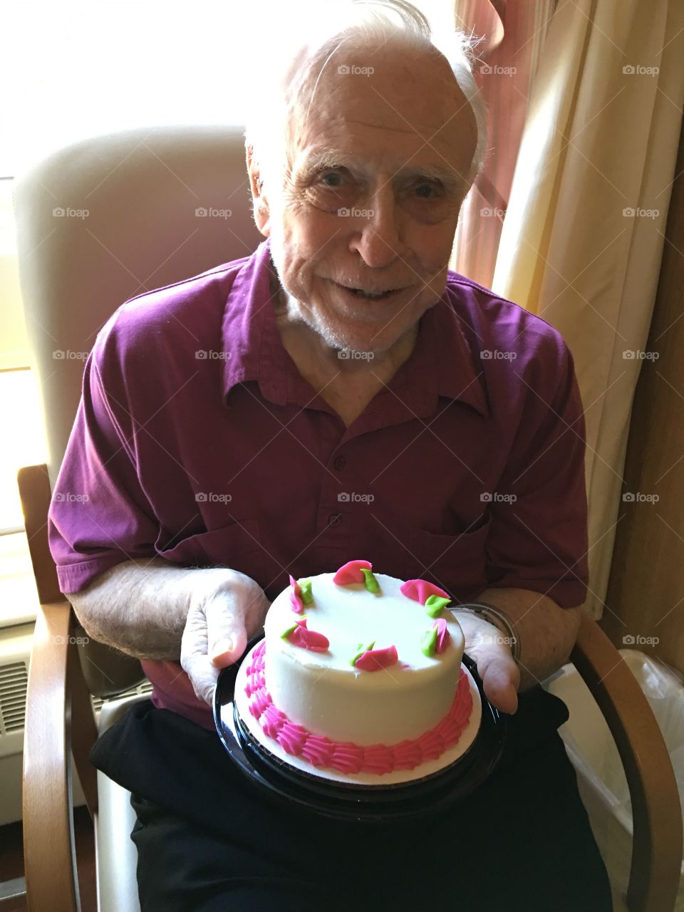 Senior man holding cake in hand