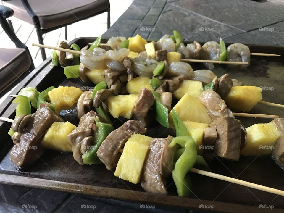 Making shish kabobs on the grill