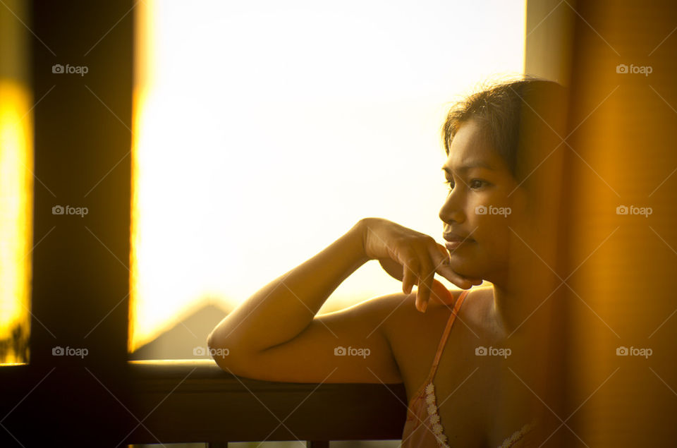 Asian lady at balcony on sunrise 