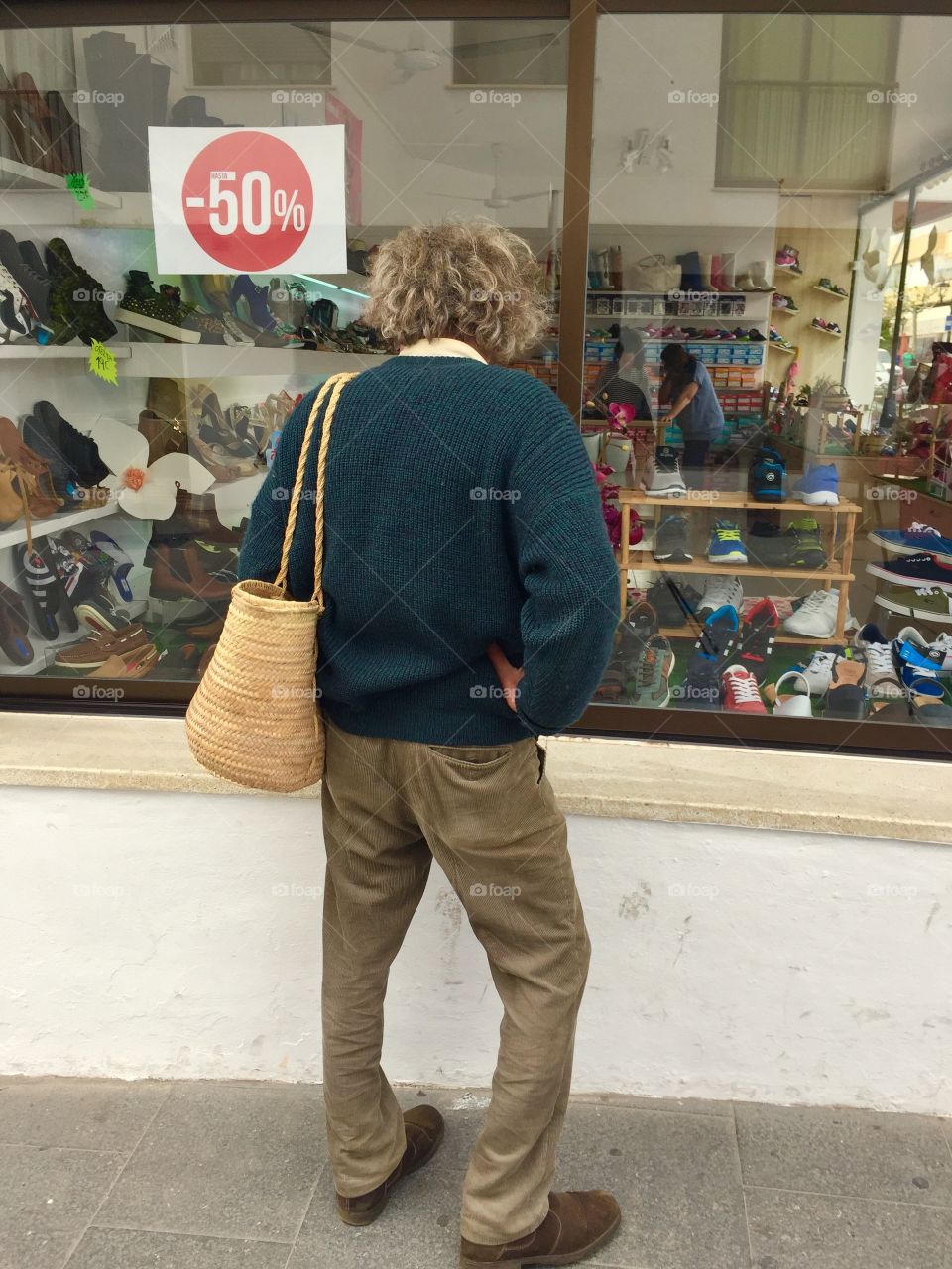 Man watching the windows of shoe shop 