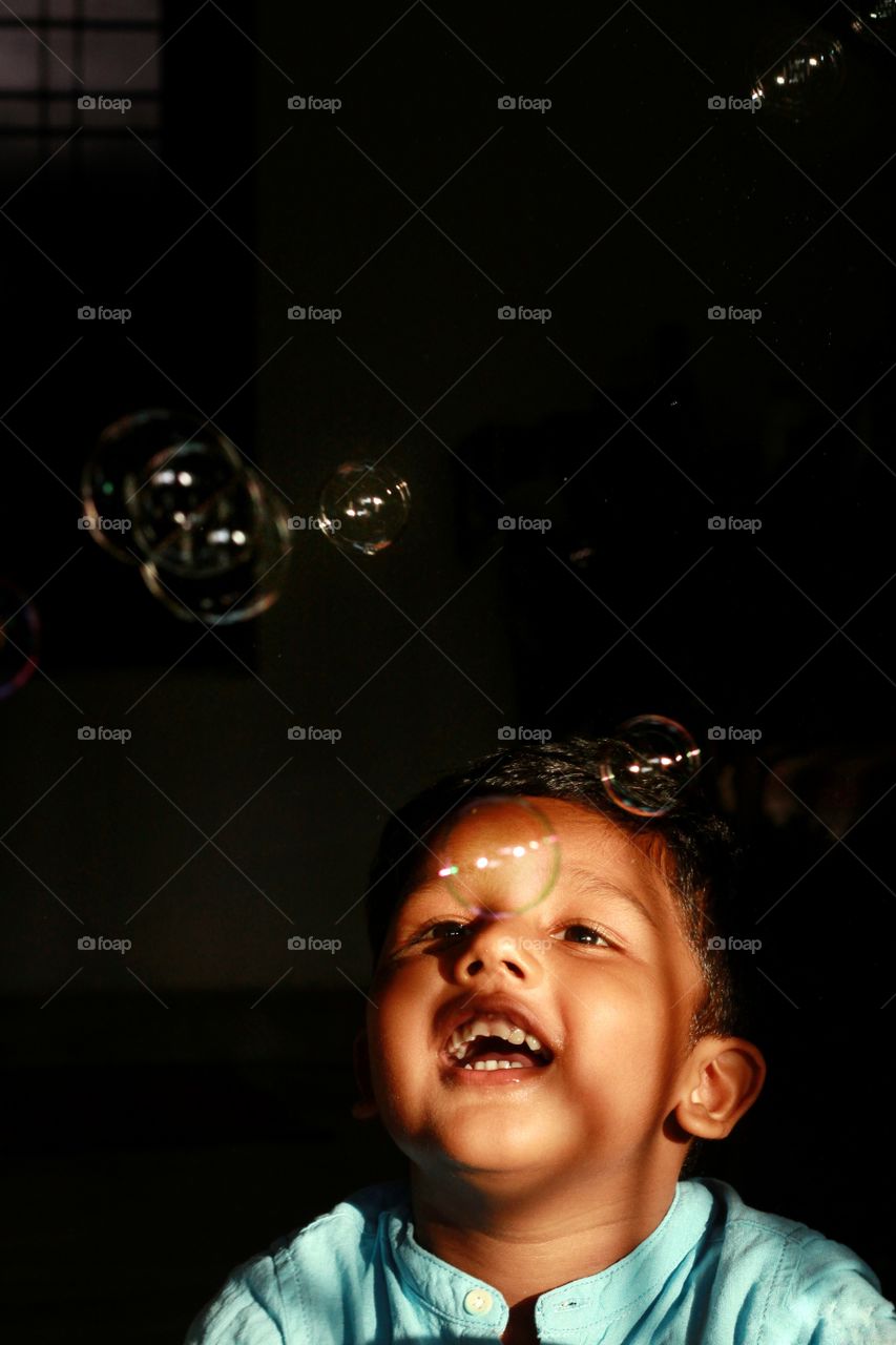 baby boy playing with bubbles