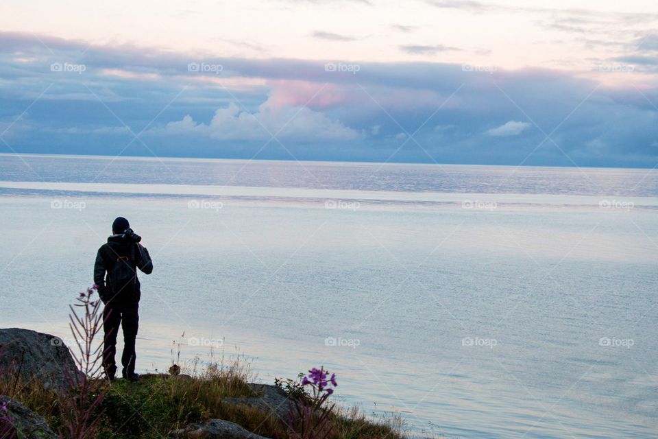 Silhouette of a man with his tripod 