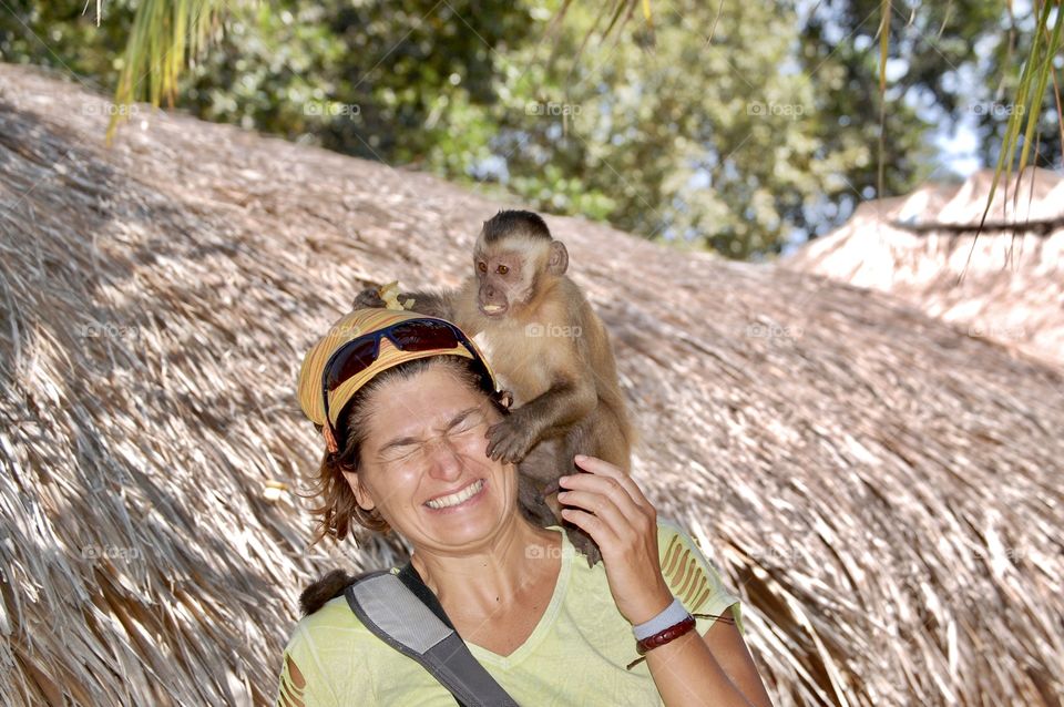 Woman with monkey eating bananas 