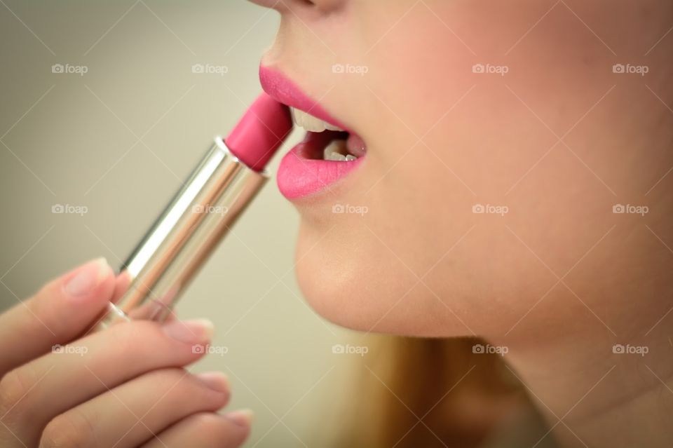 Woman Passing a Pink Lipstick