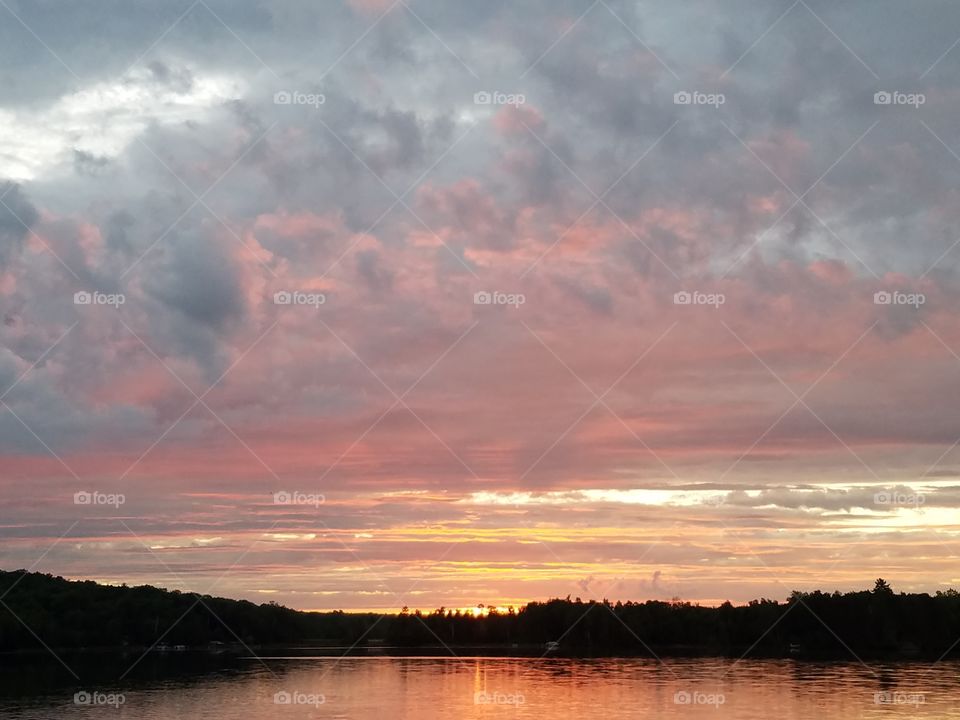 Scenic view of idyllic lake against cloudy sky