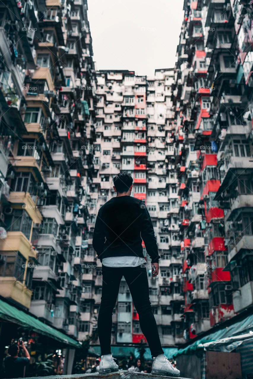 The Best Photo in Hong Kong.

A man is standing in front of a special, dense and packed building called the Monster Building in Hong Kong
