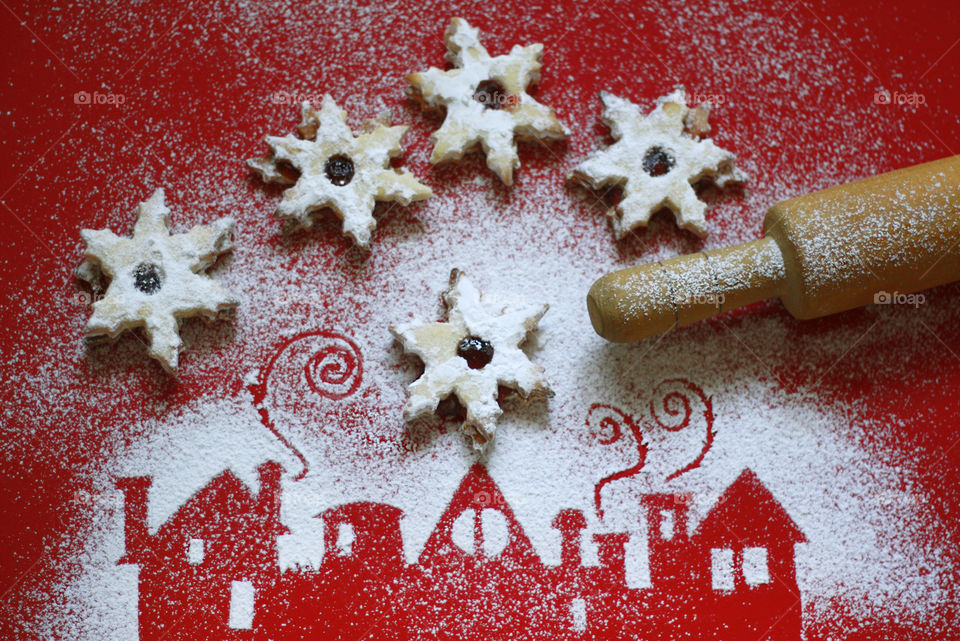 Home made Christmas cookies and silhouettes of powdered sugar houses