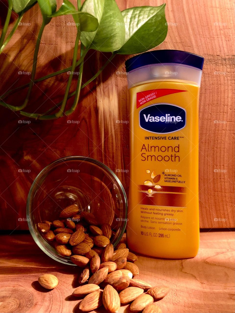 Another shot of Vaseline Almond Smooth body lotion with almonds! And a green plant for color ☺️