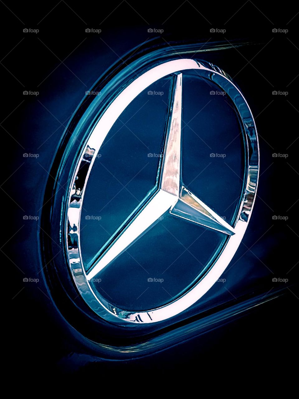 The iconic 3-point star Mercedes-Benz logo on the rear of a G-Wagon. 