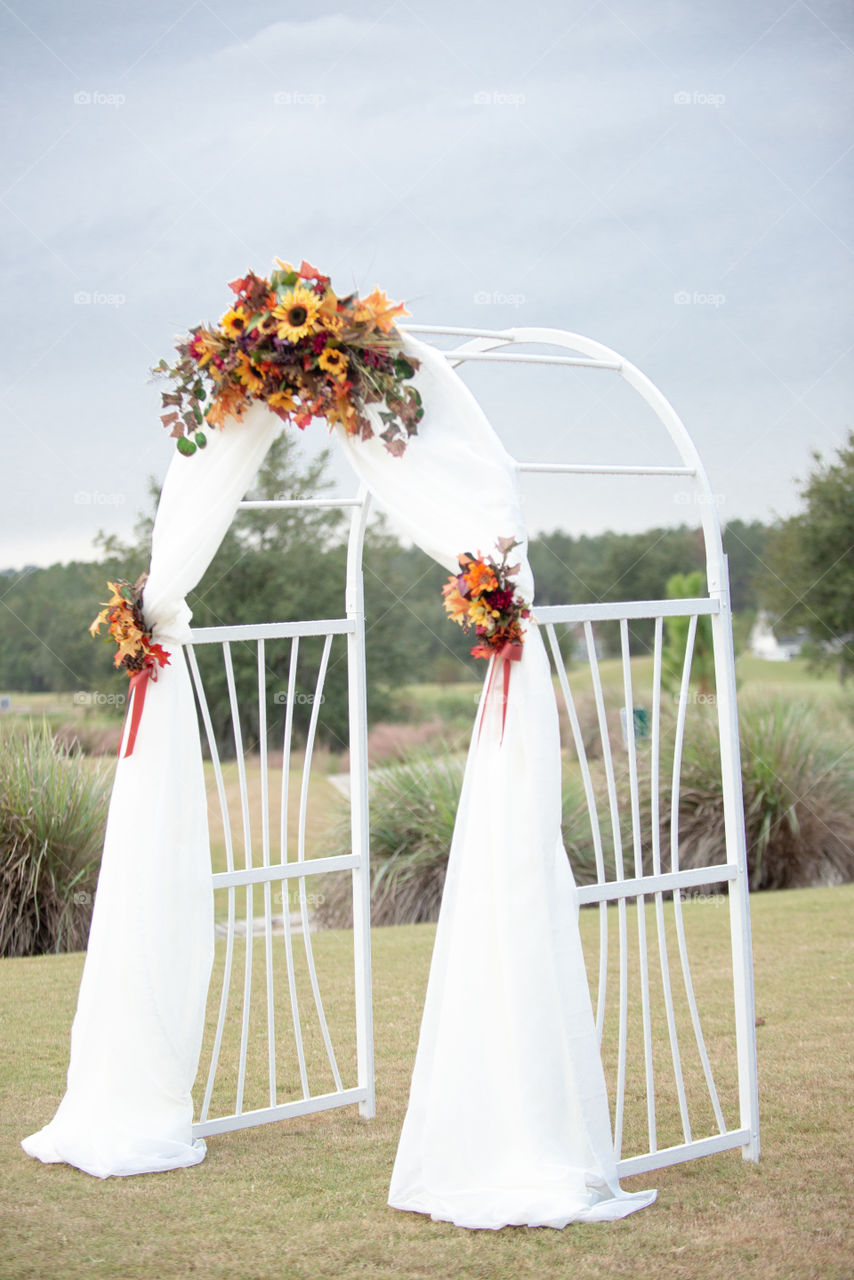 White Wedding Arch with Sunflowers
