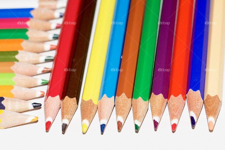 Colourful pencils on white background