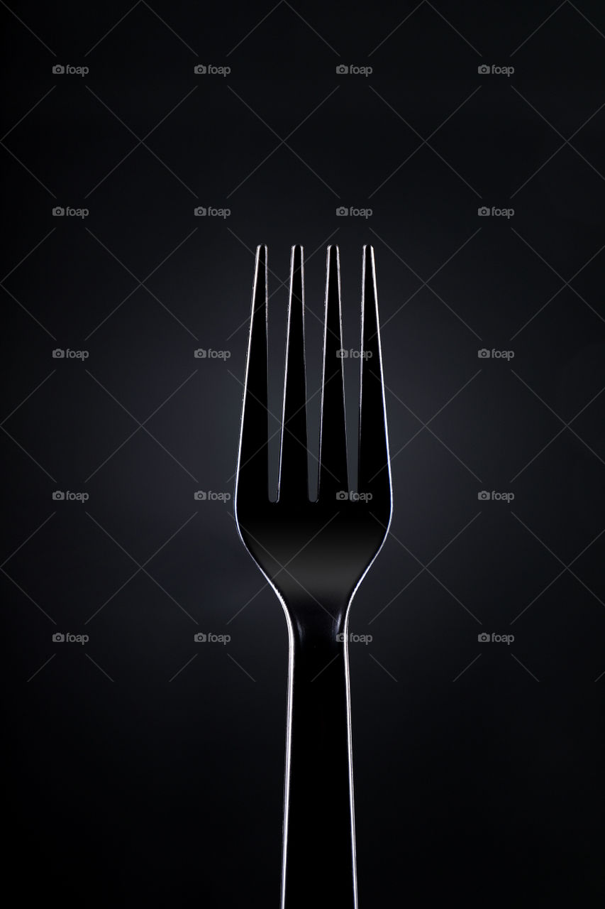 Black plaid fork on dark background