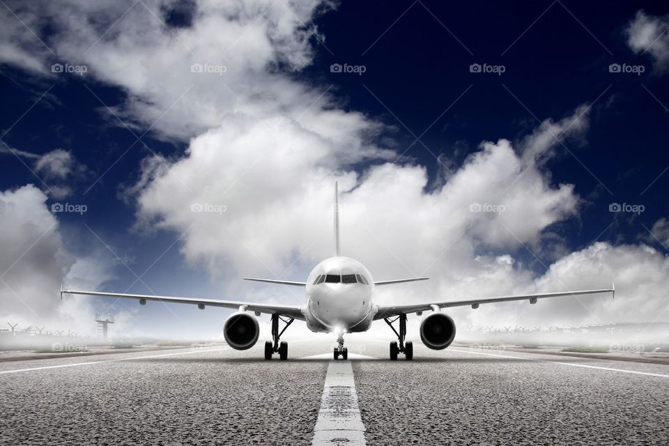 Airplane landing on runway in airport