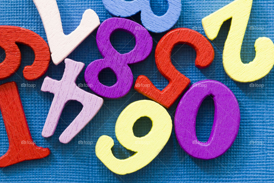 colored wooden numbers on a blue background.  make your school colorful!