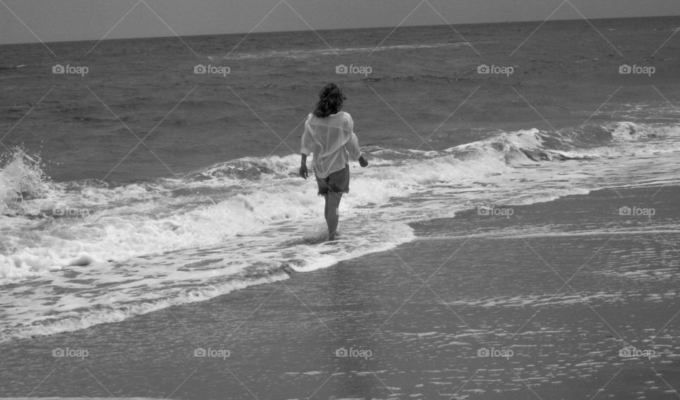 girl walking along the beach