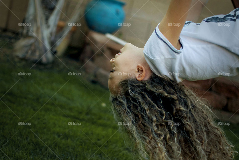 Little girl with biracial hair on swing 