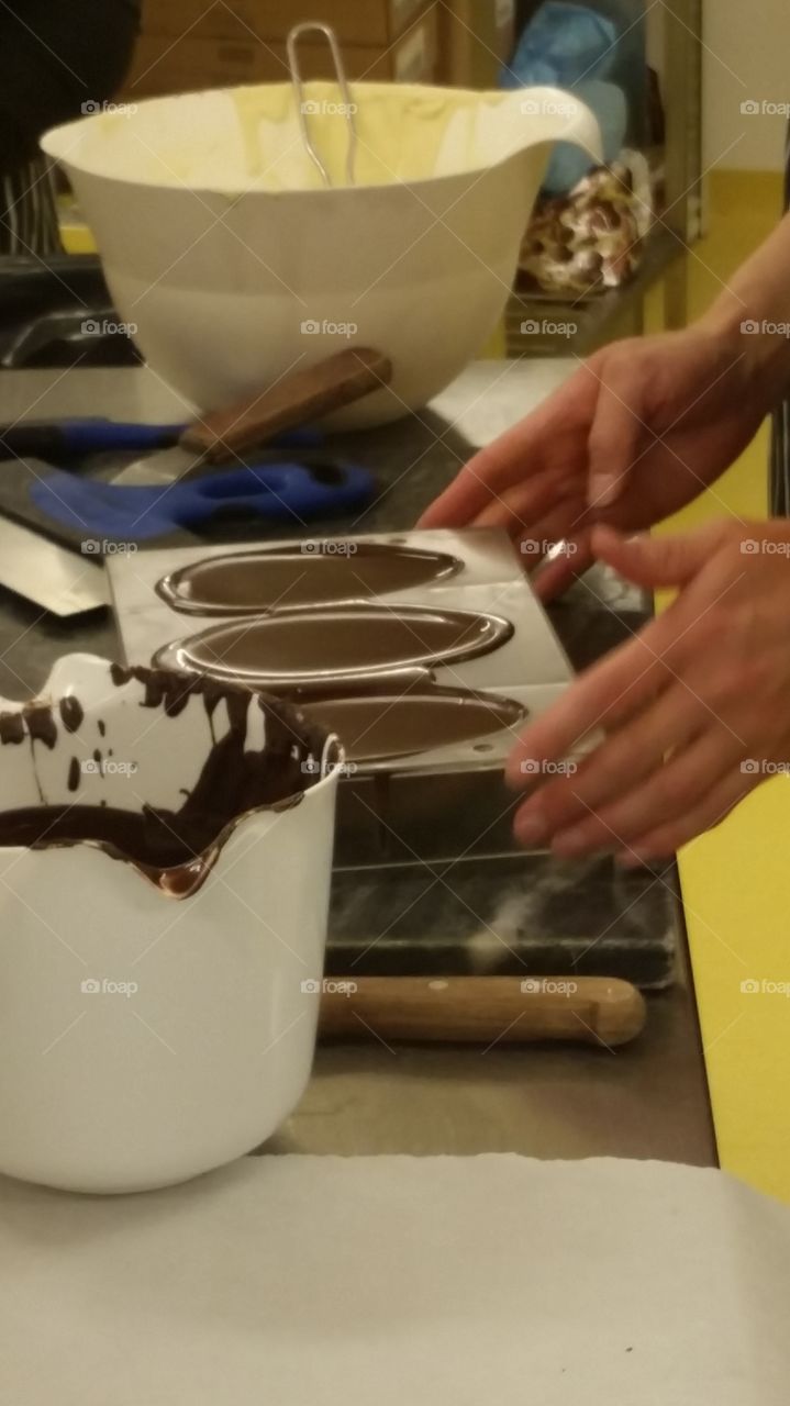 Melted chocolate in molds to make egg shells