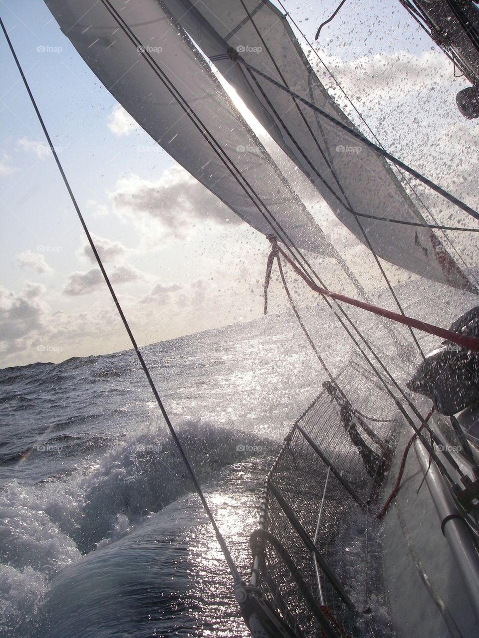 sailboat at the ocean with wind and waves