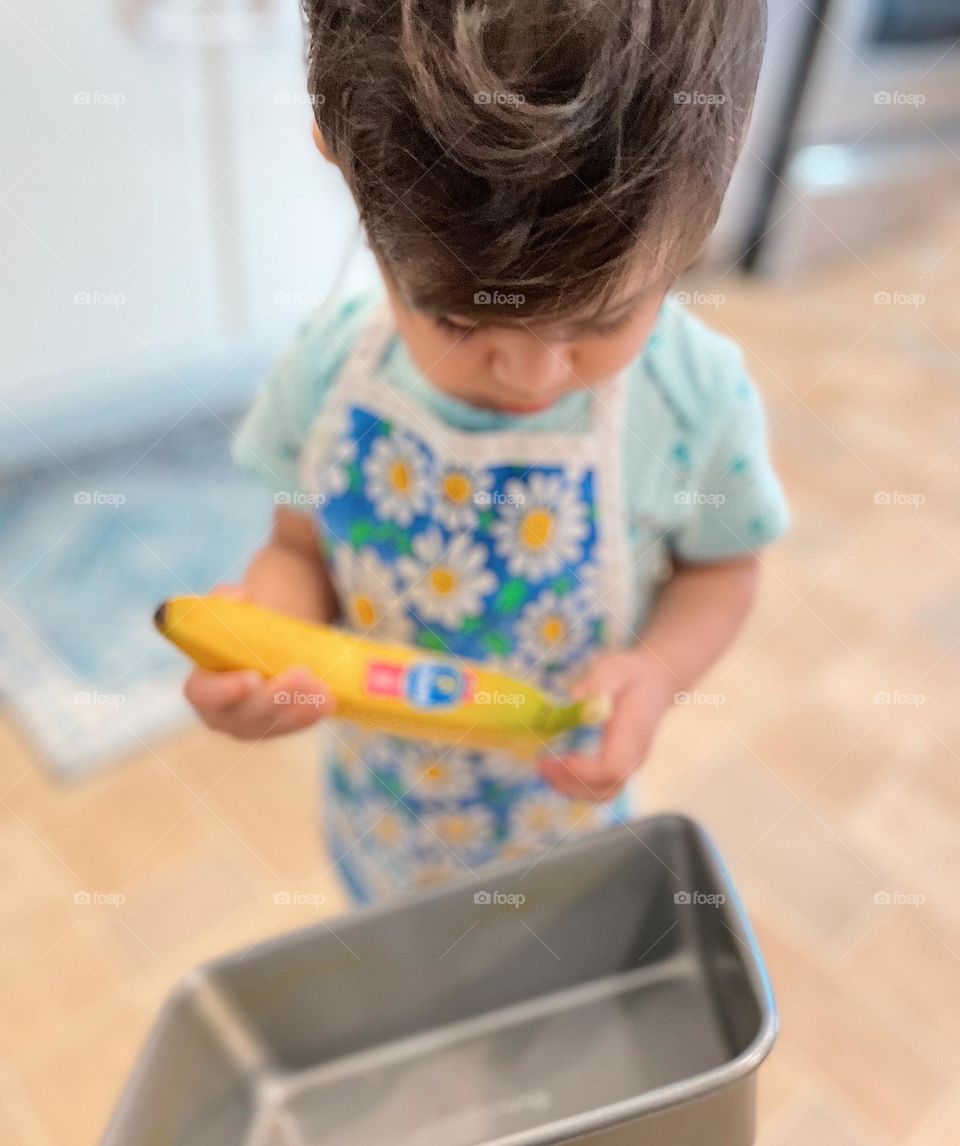 Child baking banana bread, toddler with banana, toddler in the kitchen, toddler helps bake a cake, kitchen family time 