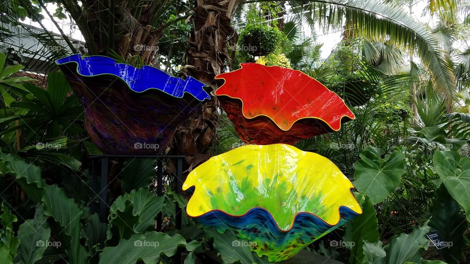 huge colorful glass bowl sculptures in a garden