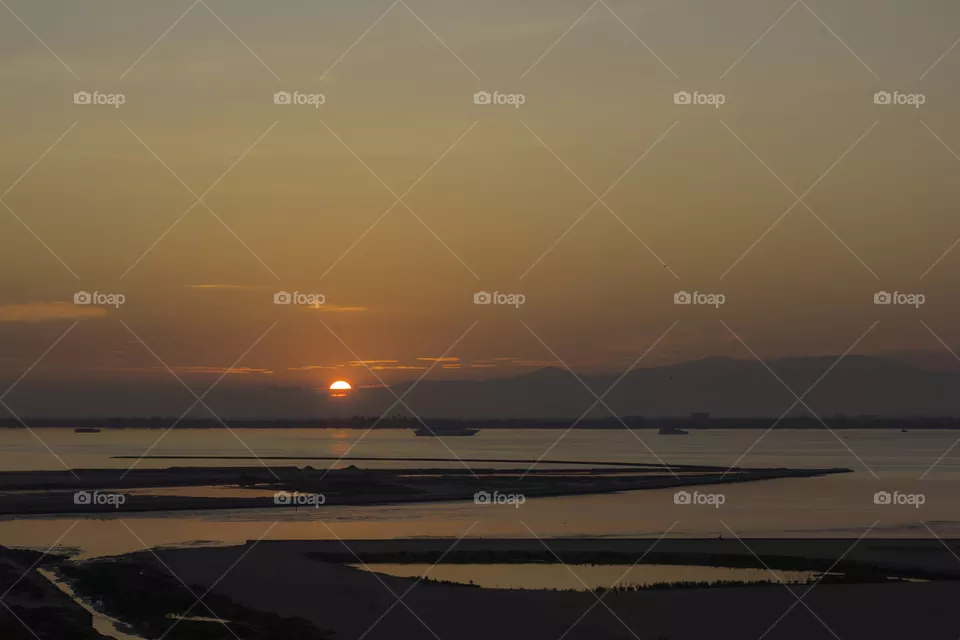 Sun rising at low tide.