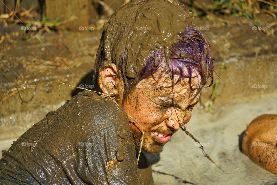 Boy Getting Messy In Mud