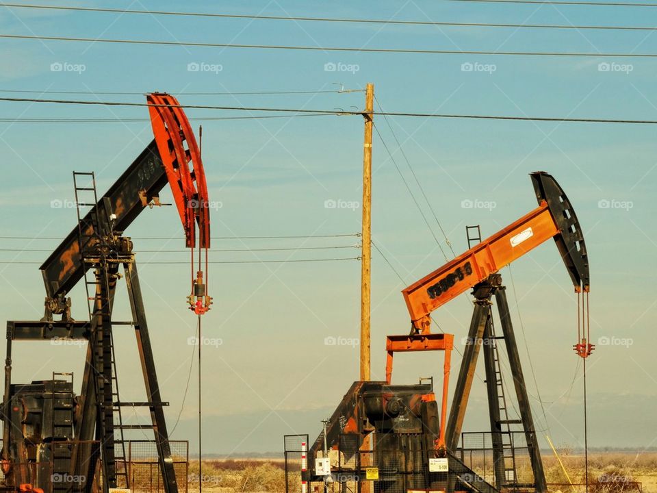 Oilfield. Oil Drilling Derricks At A Massive Desert Oilfield
