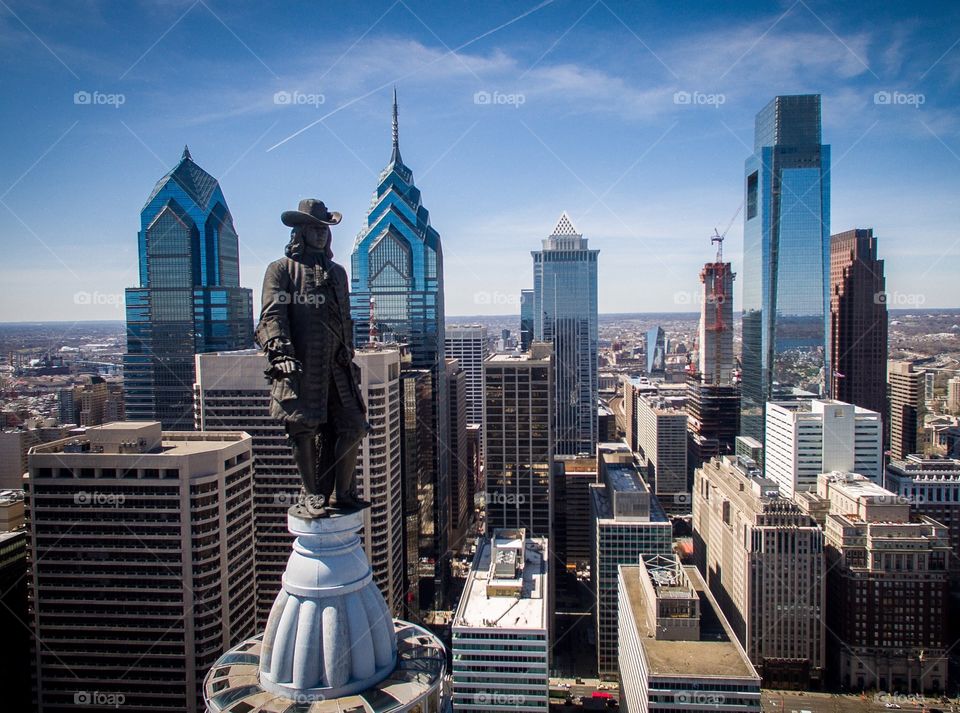 Skyline of Philadelphia from the air with the statue of William Penn atop Philadelphia City Hall in the foreground. 