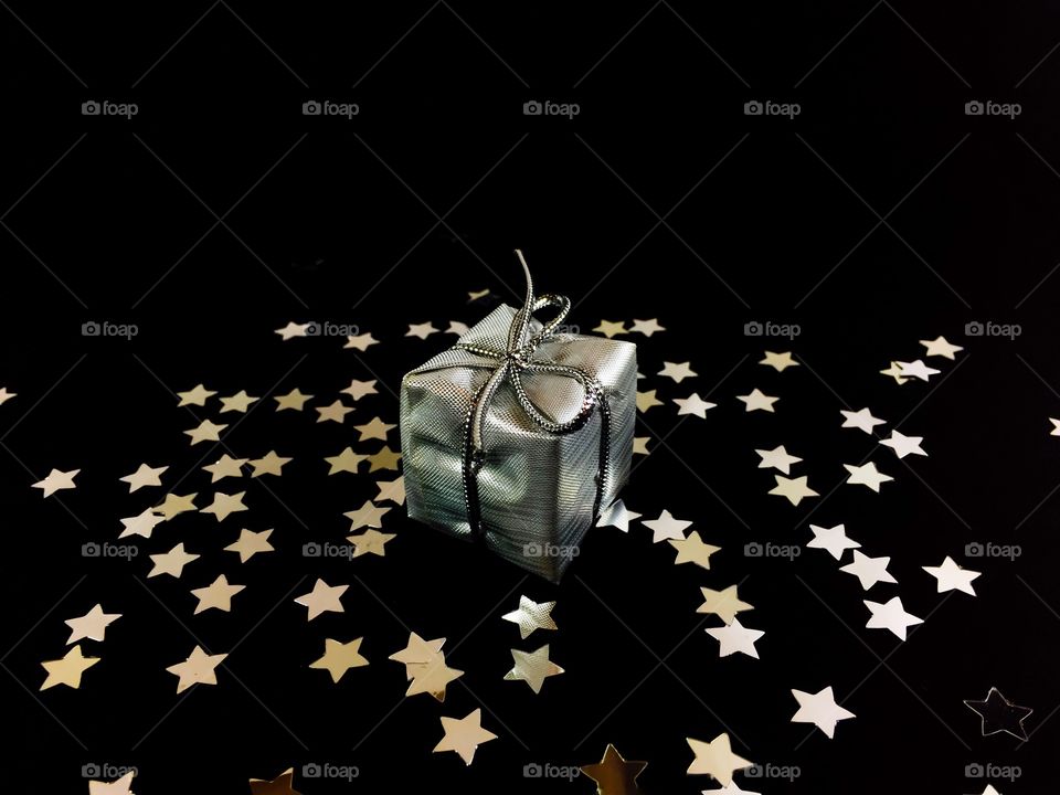 Sliver gift and star shape on black background