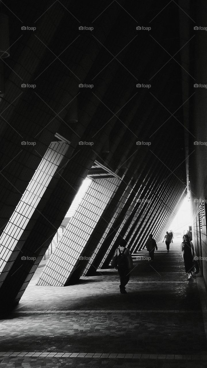 Multiple inclined pillars form a triangular passage.