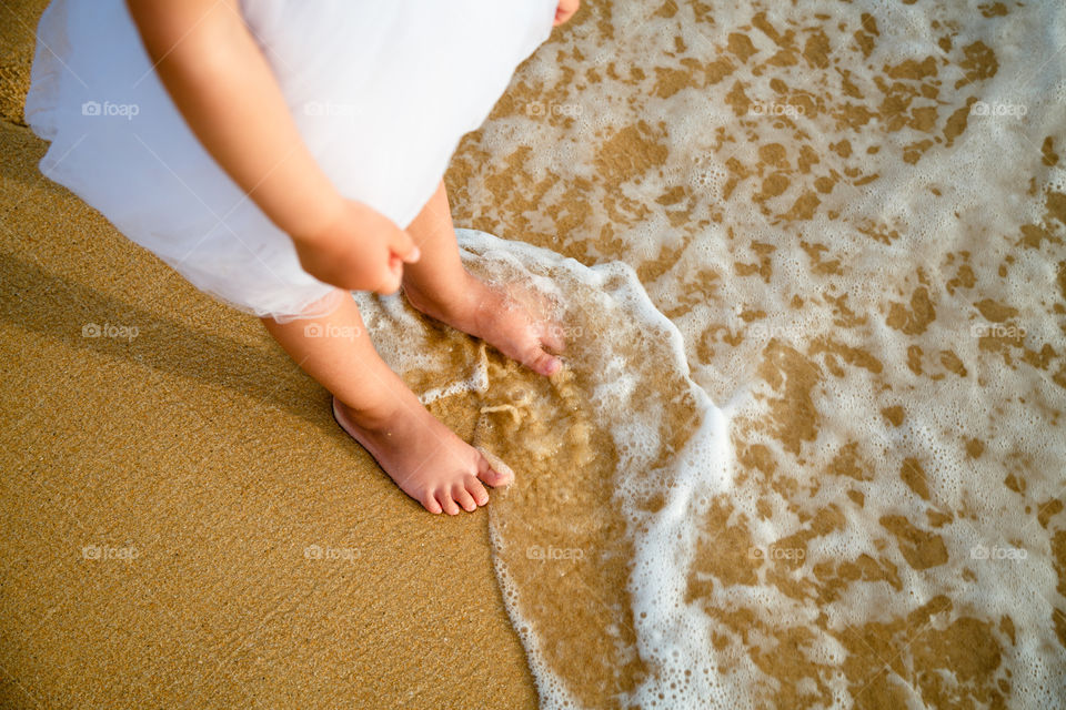 Legs on the sandy beach 