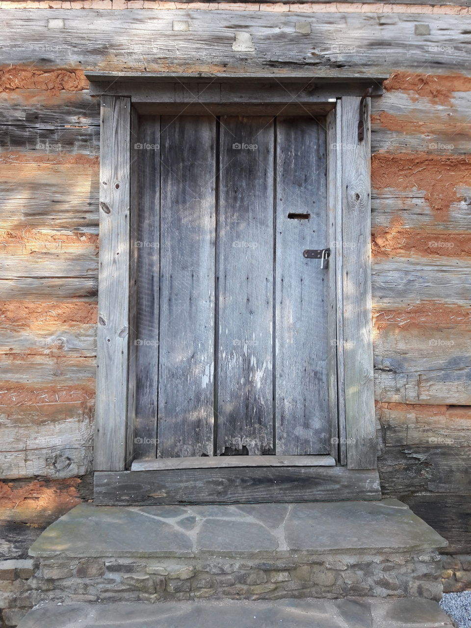 This is a close up of a cabin door from the 1700s. Everything inside was left alone so it can stay as it was from way back then.