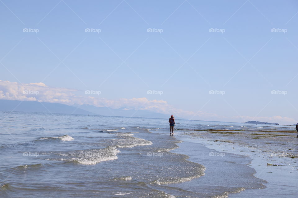 Woman walking on a beach during low tide