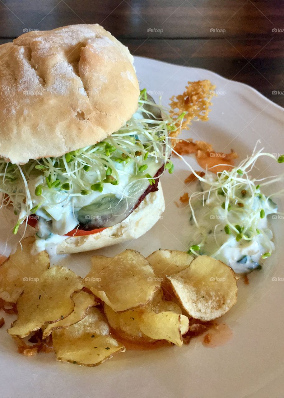 Vegetarian burger served with chips 