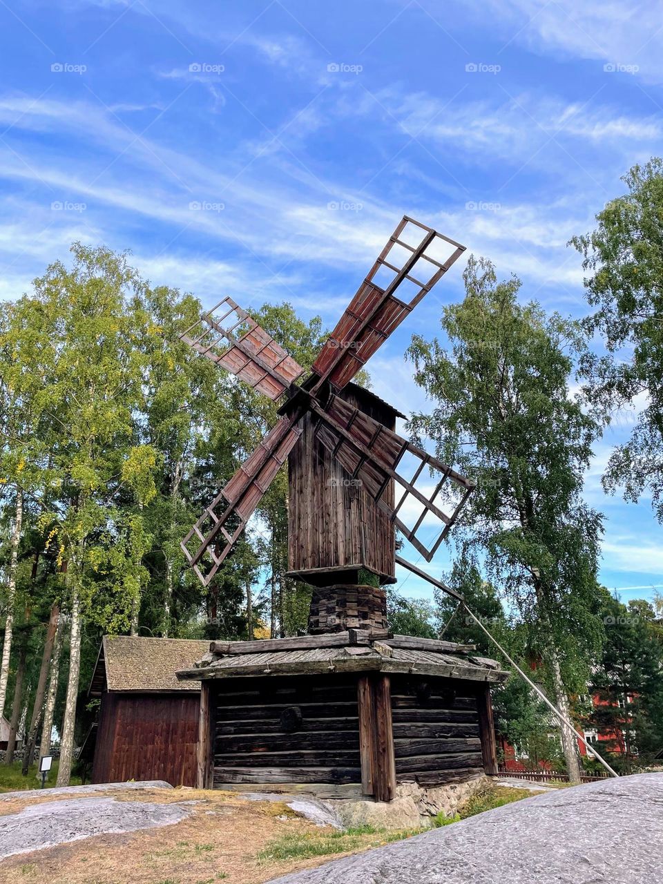 Side view of the old wooden grain mill with storage reservoir under