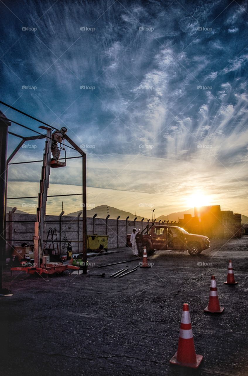 man putting together a structure, supervised