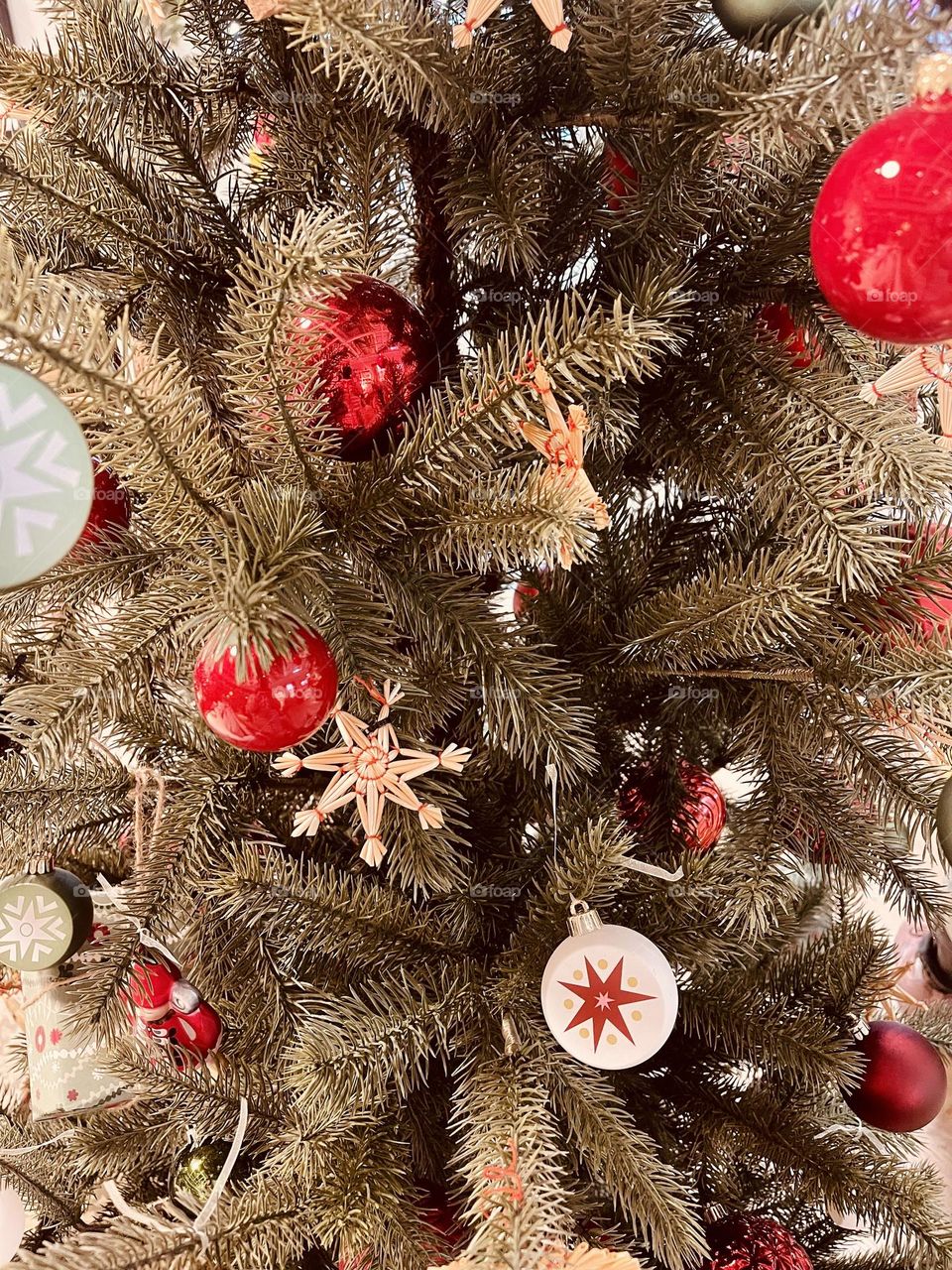 Christmas tree decorated with glass balls and other ornaments, festive season celebration 