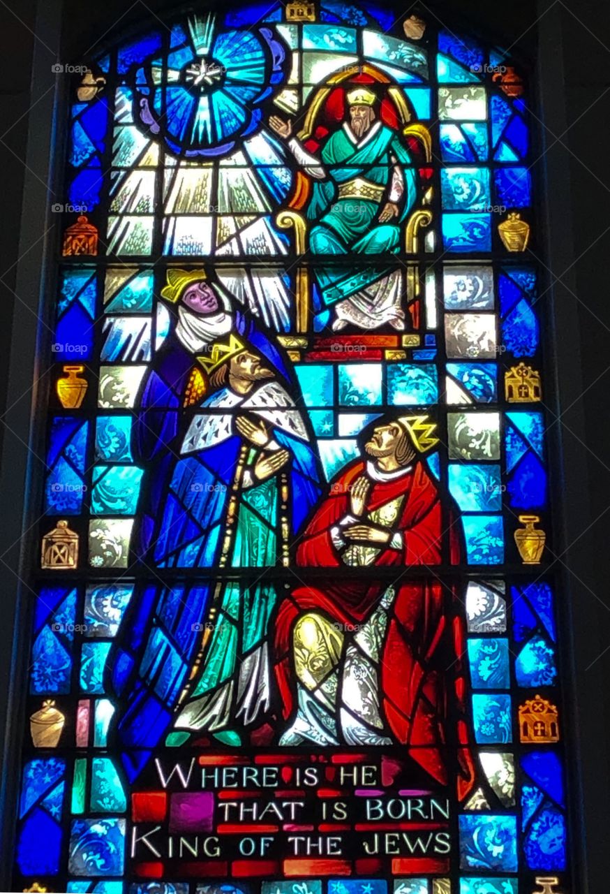 Stained Glass image of the Three Wise Men speaking to King Herod