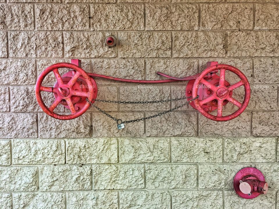 Red hardware on a block wall