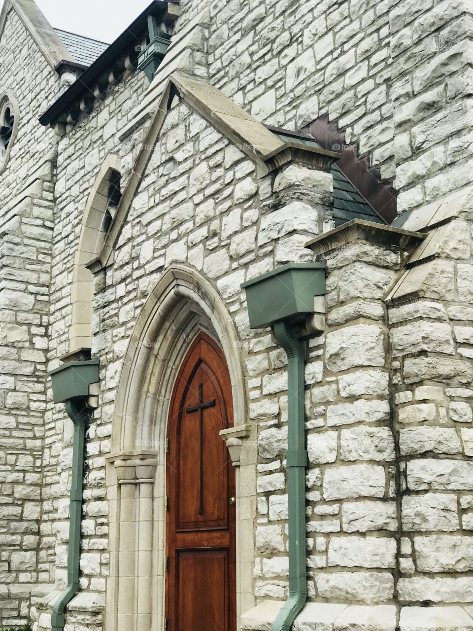 This Church entrance is absolutely stunning with the contrast of the beautiful wooden Cross door against the light stone. 