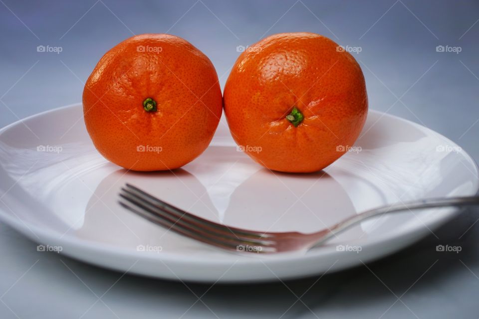 Two tangerine on plate 