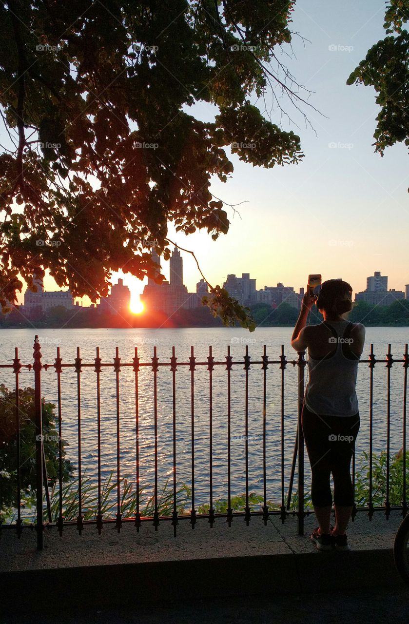 Girl Taking Photo of Sunset