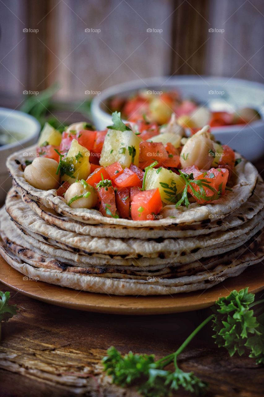 Stacked Chapati's and spicy salsa toppings.