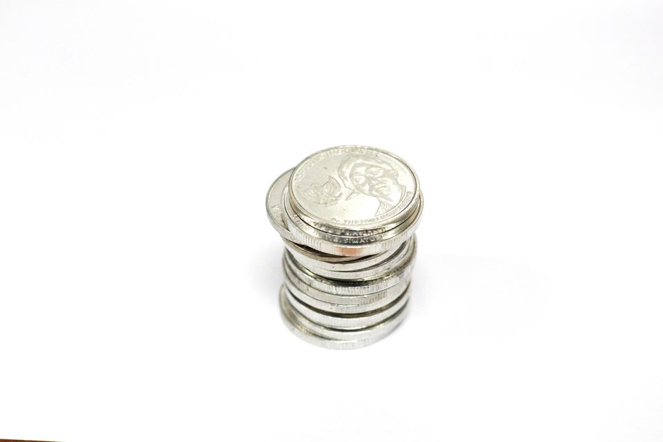 One form of currency is a coin, this is a photo of coin money with a white or clean background